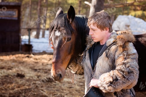 Preview: a man feeding a horse with oats