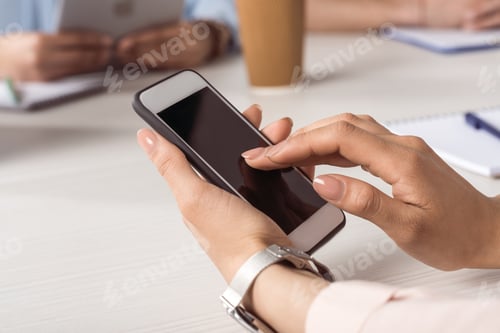 Preview: cropped shot of woman using smartphone with blank screen