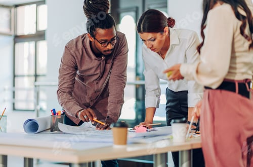Preview: Arabic architect with dreadlocks having a meeting with his colleagues in an office