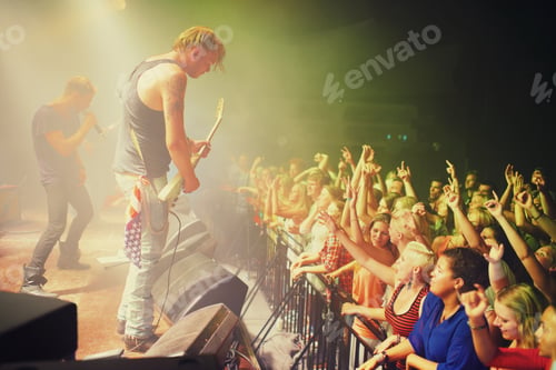 Preview: The most epic show of their lives. Young people getting into the music at an awesome concert.