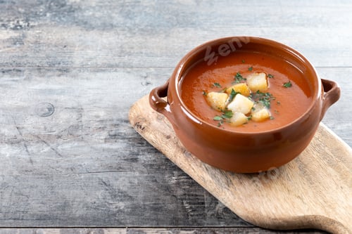 Preview: Traditional Spanish Gazpacho soup in bowl on wooden table