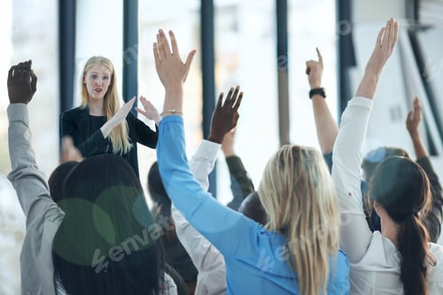 Preview: Shot of a group of people raising their hands in a class