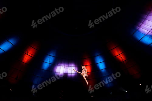 Preview: low angle view of artistic aerial acrobat performing in circus