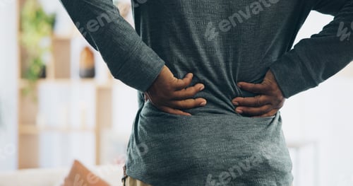 Preview: Black person, back and injury with pain for bad posture, muscle tension or herniated disc at home.