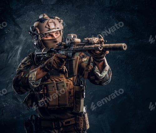 Preview: Special forces soldier in camouflage uniform holding an assault rifle with a laser sight