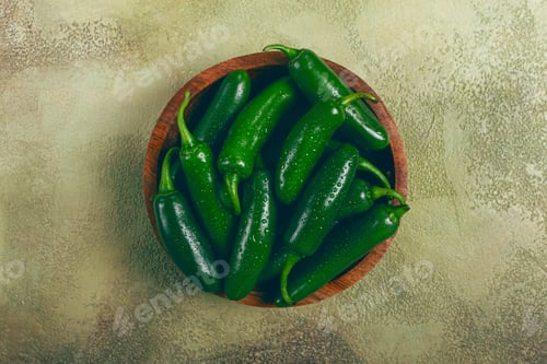 Preview: fresh padron pepper, raw, in a wooden bowl, on the table, there are no people.