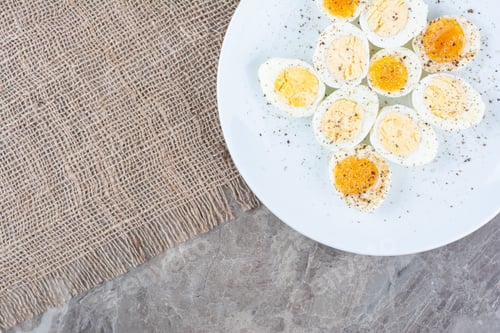 Preview: Boiled tasty eggs with spices on white plate