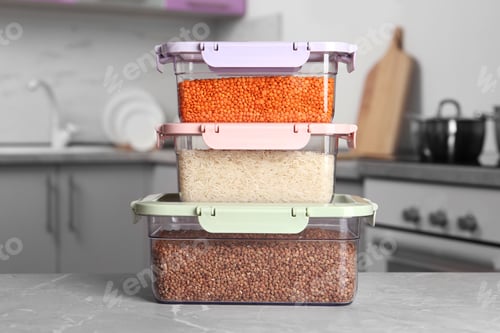 Preview: Stacked boxes with different food on table in kitchen