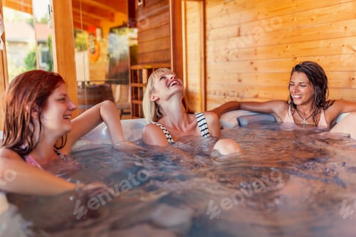 Preview: Girl friends relaxing in a hot tub while on a vacation