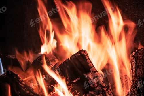 Preview: Fire orange tongues on black background in a brick fireplace