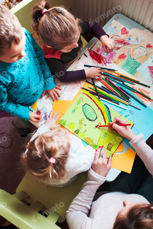Preview: Mom with her little daughters and son together drawing a colorful picture of playing children using