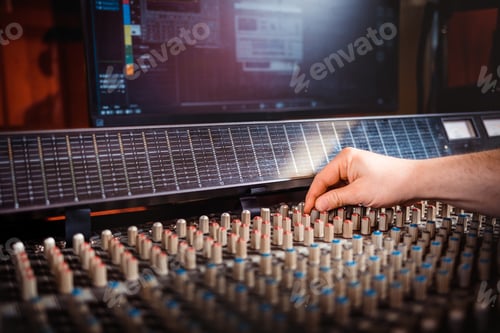 Preview: Sound producer working at recording studio using soundboard and monitors