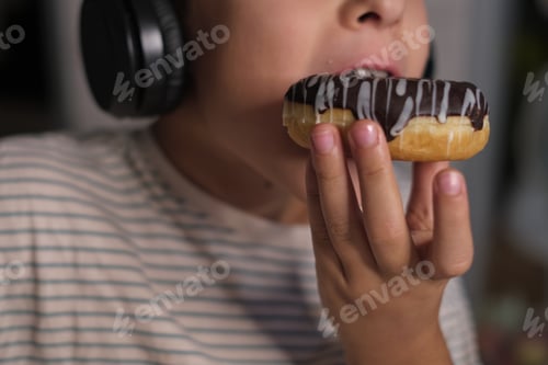 Preview: The simple joys of childhood captured as a child listens to music and enjoys a tasty donut, blending