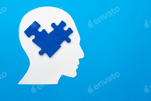 Preview: Papercut head with jigsaw puzzle pieces on blue background