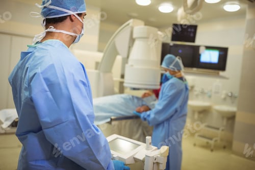 Preview: Surgeons examining patient in operation theater