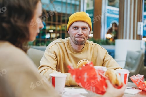 Preview: Young family couple friends eat fast food at food court in shopping mall