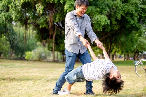 Preview: Asian father playing with son in the park