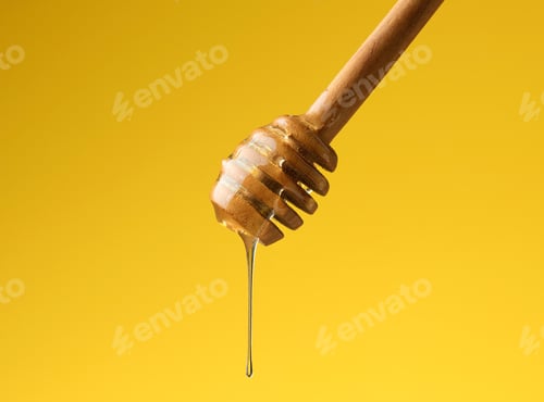 Preview: Pouring transparent sweet honey from a wooden stick. Yellow background. Food levitates