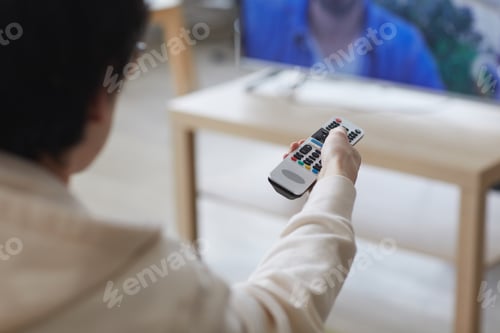Preview: Young Man Holding TV Remote Close Up