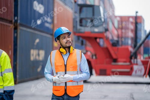 Preview: Technician working checking stock into container for loading at container yard warehouse.