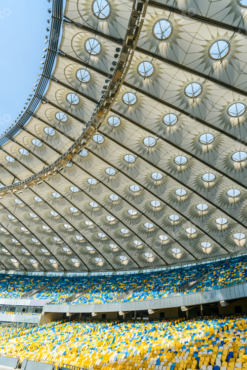 Preview: rows of yellow and blue stadium seats on olympic stadium