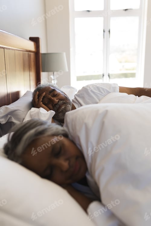 Preview: Close-up of a senior African American couple sleeping in bedroom at home