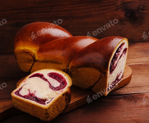 Preview: Delicious homemade bread with berry filling served on wooden board
