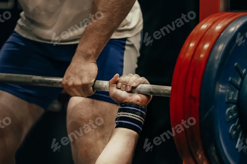 Preview: hand male powerlifter hold barbell bar before bench press powerlifting