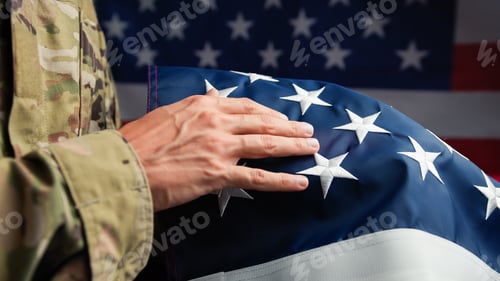 Preview: Hand of a Veteran touching stars of USA flag