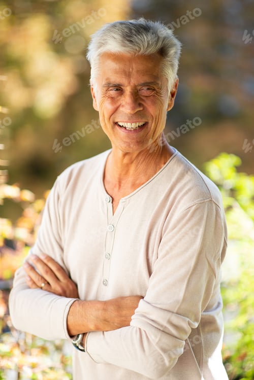 Preview: Close up handsome older man smiling with arms crossed