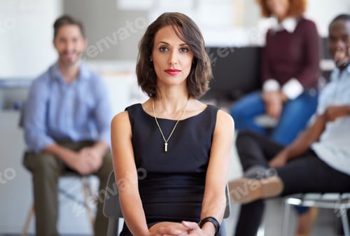 Preview: Portrait of an attractive businesswoman with coworkers in the background