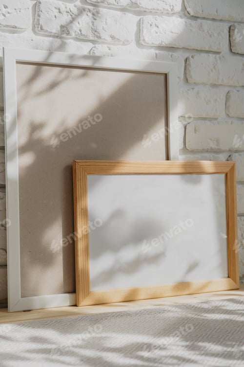 Preview: Photo frames on floor over white brick wall
