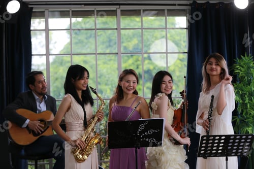 Preview: Women musical band playing instruments in background. Online home studio plays and sing a song.