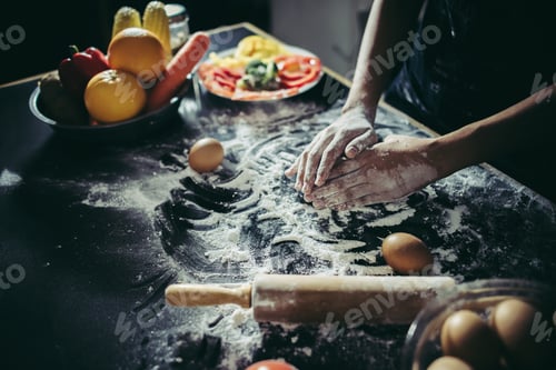 Preview: Woman kneads dough for make pizza on wooden. Cooking concept.