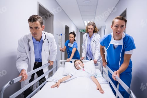 Preview: Doctors pushing emergency stretcher bed in corridor