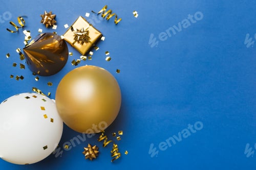 Preview: Holiday background with colorful balloon, gift and confetti. Flat lay style.
