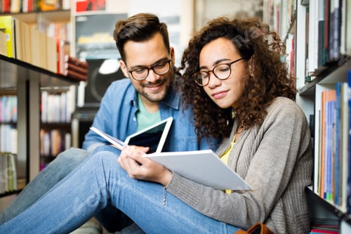 Preview: Students are studying together in library. Couple, study, technology, education love concept