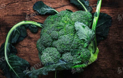 Preview: Fresh organic broccoli cabbage on old rustic wooden kitchen table background, top view