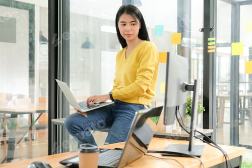 Preview: Female programmer are using laptop to place on the leg and create programs for clients.