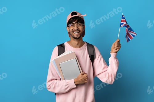 Preview: Happy arabic guy student showing flag of UK