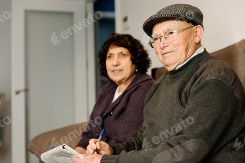 Preview: Elderly couple reading a newspaper.