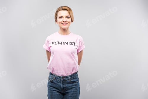 Preview: smiling woman in pink feminist t-shirt, isolated on grey