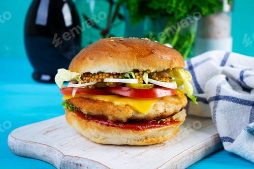 Preview: Tasty chicken burger with lettuce, cheese, tomato and pickle. Fast food sandwich with chicken cutlet