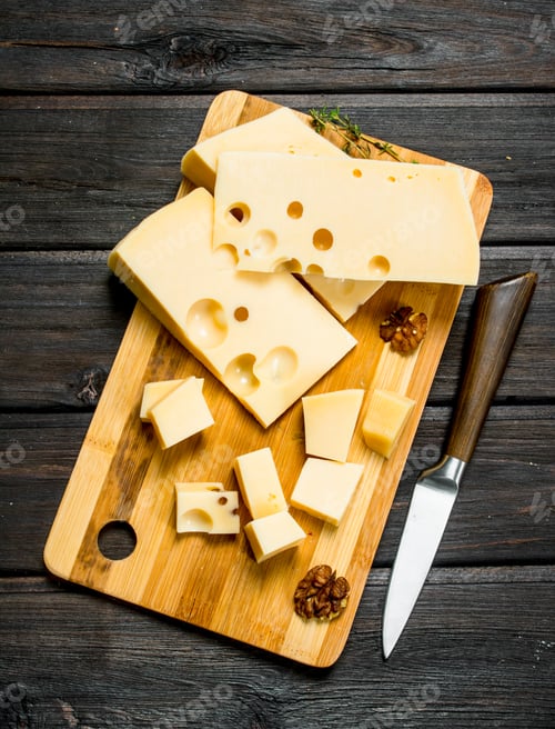 Preview: Fresh cheese with nuts on a wooden Board.