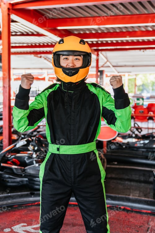 Preview: Chinese man celebrating victory wearing racing suit at karting track