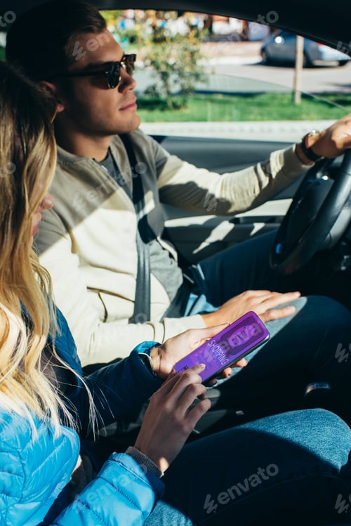 Preview: woman using smartphone with shopping lettering on screen while husband driving car