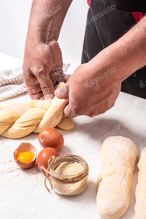 Preview: Baker's hands weave bread dough. Israeli authentic food. mixing powder