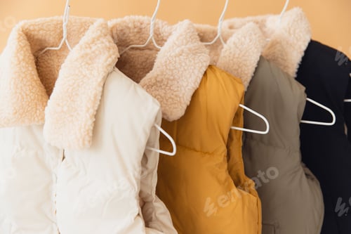 Preview: Winter sleeveless jackets hanging on rack