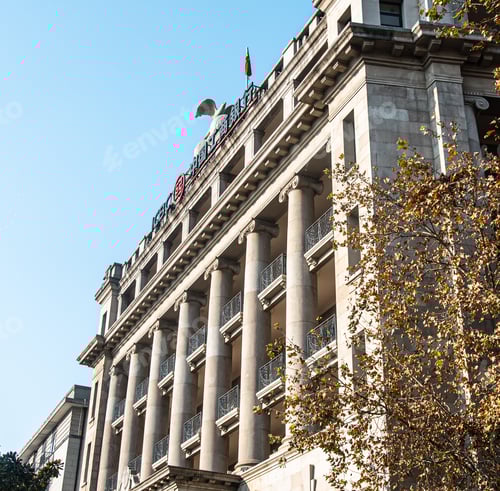 Preview: the building with stone columns on it has a clock tower at the top