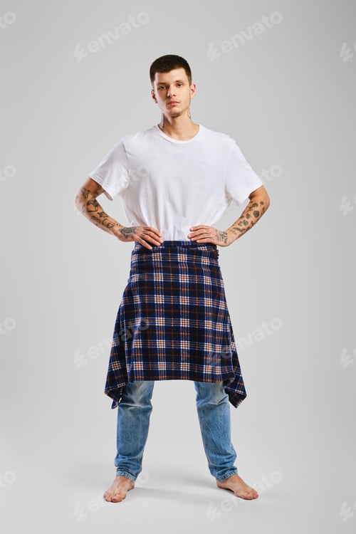 Preview: Young bold man in t-shirt, jeans and checkered shirt tied at the waist